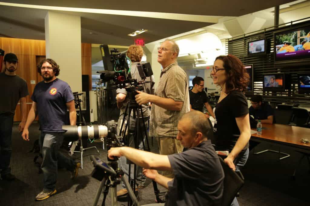 Active production scene with multiple people in frame
